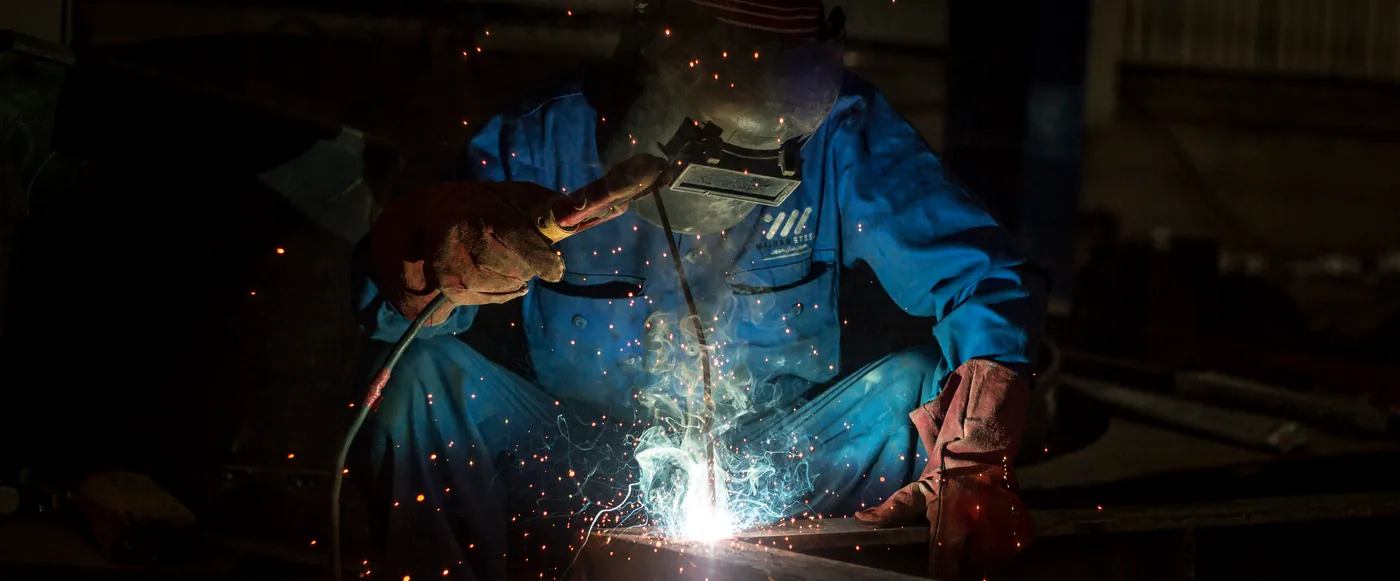 Welder in a Maihan Steel uniform